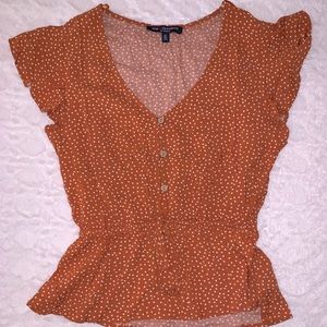 Orange and white polka dot top